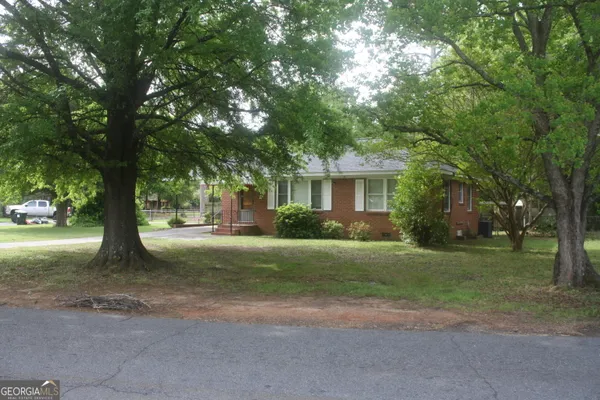 a view of a house with a tree in the forest