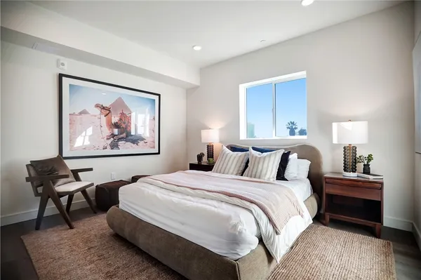 a bedroom with a bed and a painting on the wall