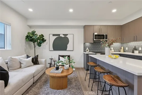 a living room with furniture and a potted plant