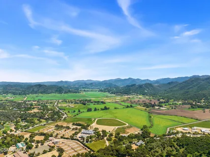 a view of a lush green hillside and houses