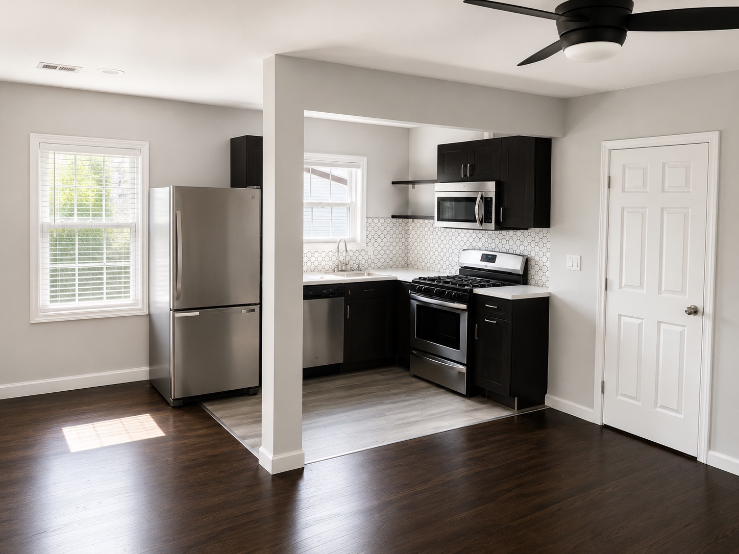 1825 1/2 Santa Rosa Street Houston, TX 77023 - Photo 1 of 7 a kitchen with stainless steel appliances a refrigerator a sink a stove a microwave and wooden floor