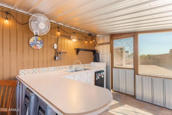 a view of a room with wooden floor and iron stairs