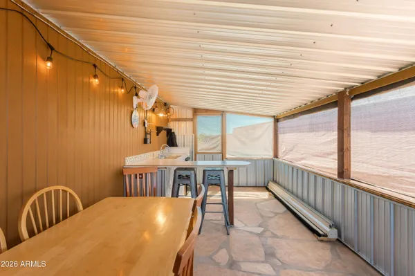 a dining room with a wooden table and chairs