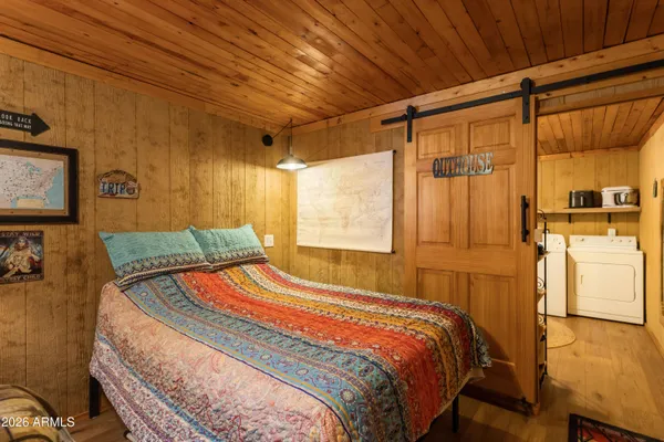 a bedroom with furniture and a chandelier