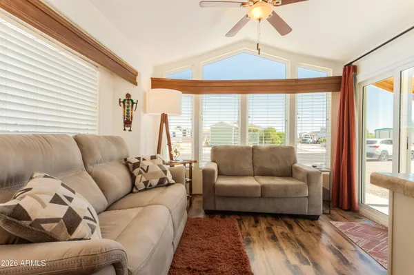 a view of a dining room with furniture and a large window