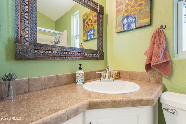 a bathroom with a toilet sink and a mirror