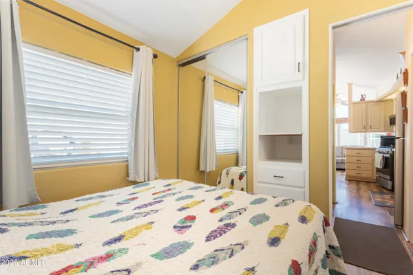 a bedroom with a bed and a mirror