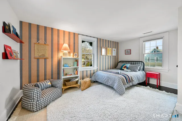 a bedroom with bed and large window