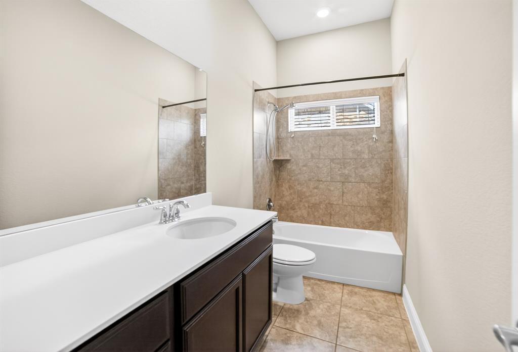 552 Winnetka Drive Oak Point, TX 75068 - Photo 8 of 40 a bathroom with a sink a toilet and shower