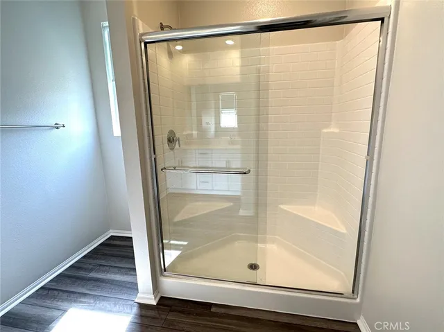 a bathroom with a glass shower door