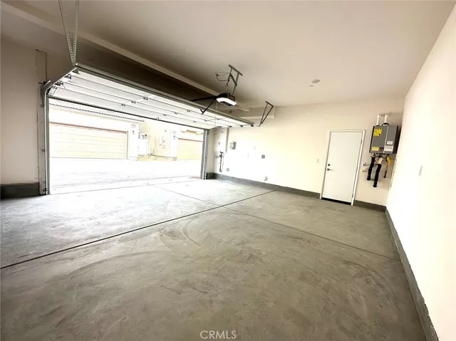 a view of an empty room with a kitchen