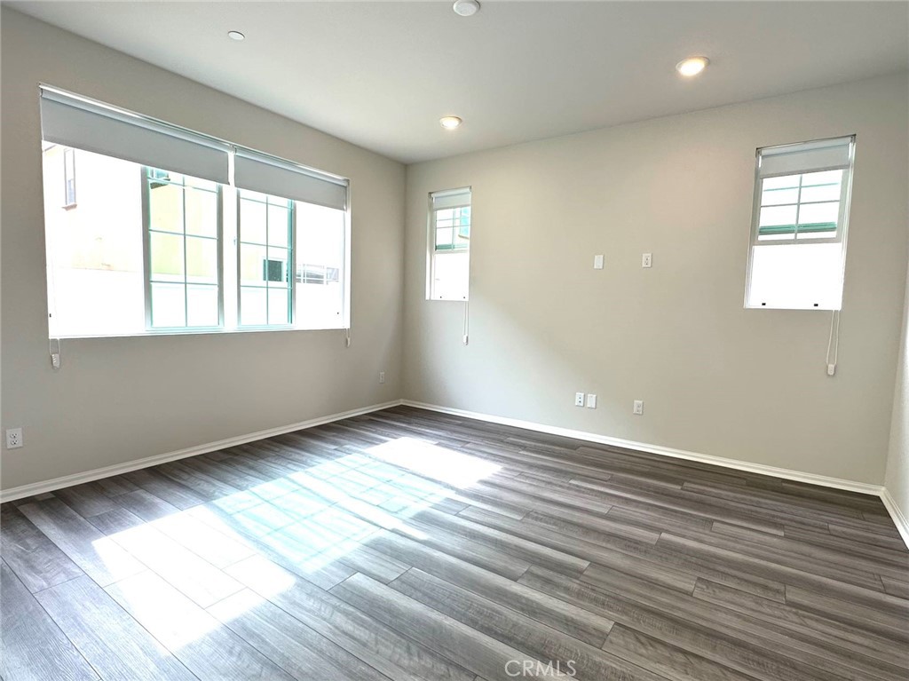 28221 Ashtree Street Temecula, CA 92591 - Photo 3 of 21 an empty room with wooden floor and windows