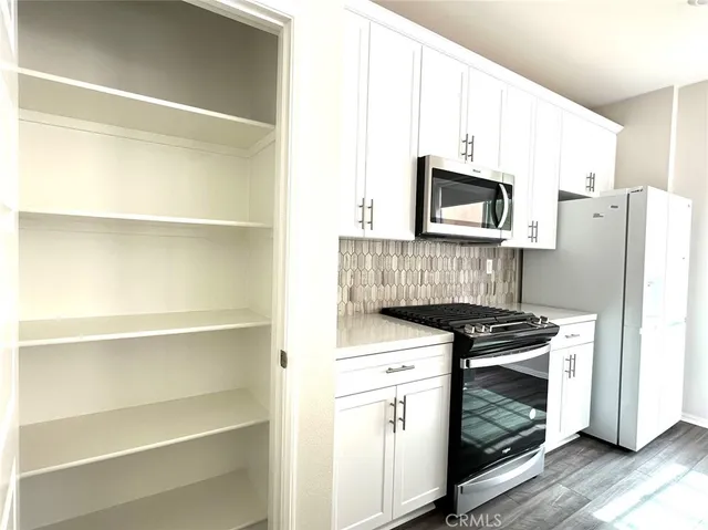 a kitchen with a stove and a microwave