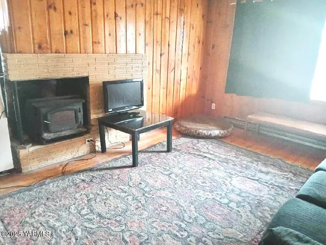 a living room with a fireplace furniture and a window