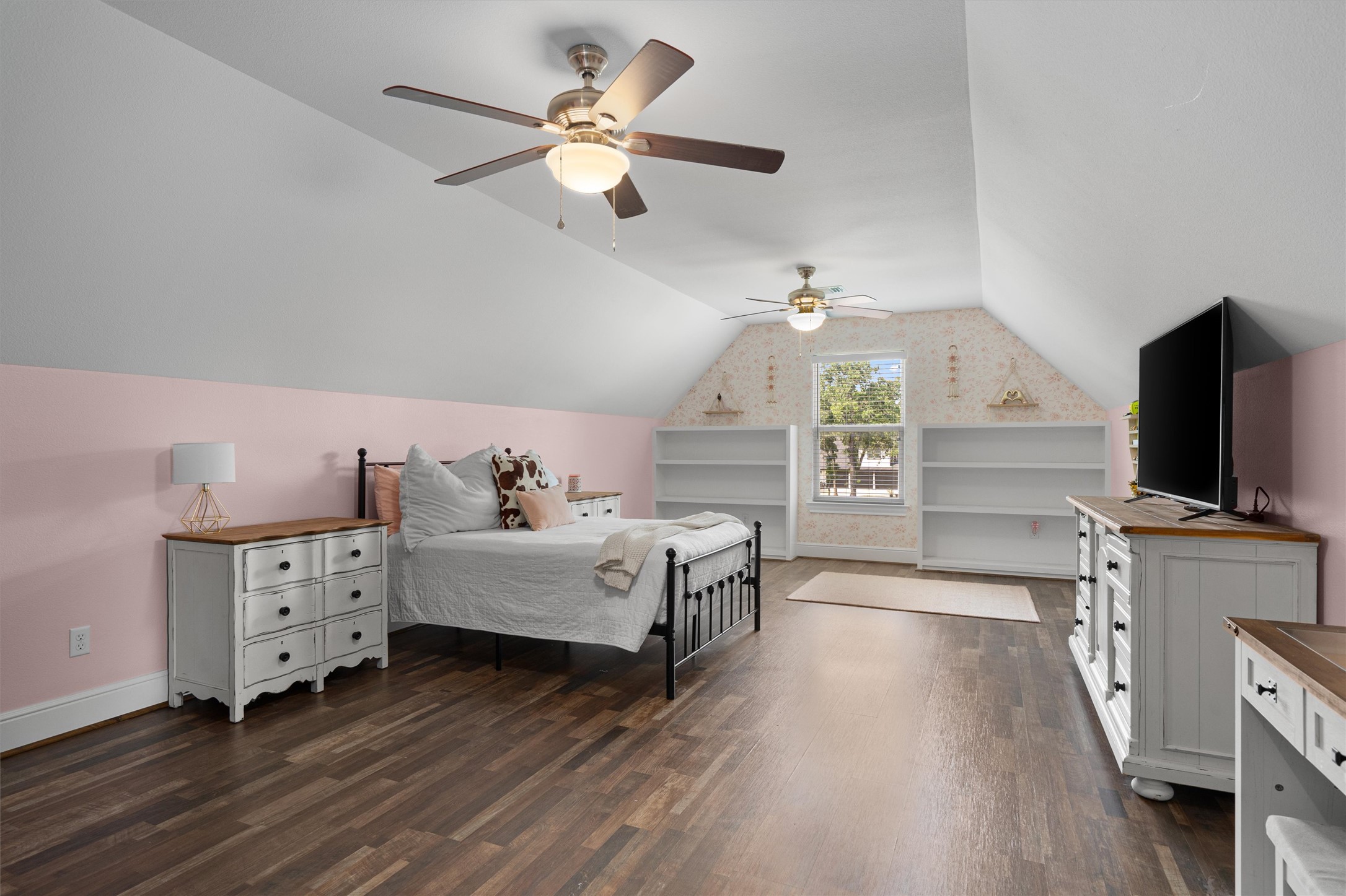 136 Fawn Hollow Elgin, TX 78621 - Photo 31 of 40 Spacious flex space, currently a bedroom, featuring vaulted ceilings, wood-finish flooring, and dual ceiling fans.