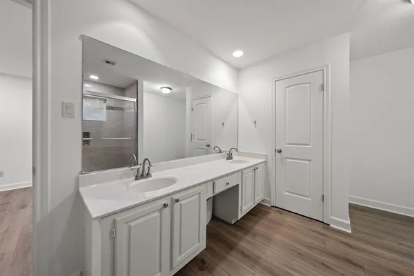 an empty room with a ceiling fan and wooden floor
