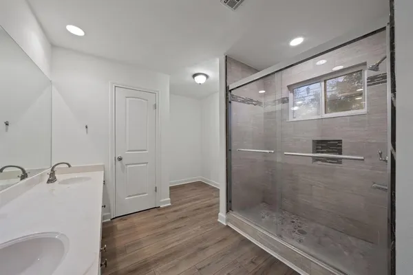 a bathroom with a sink double vanity and a mirror