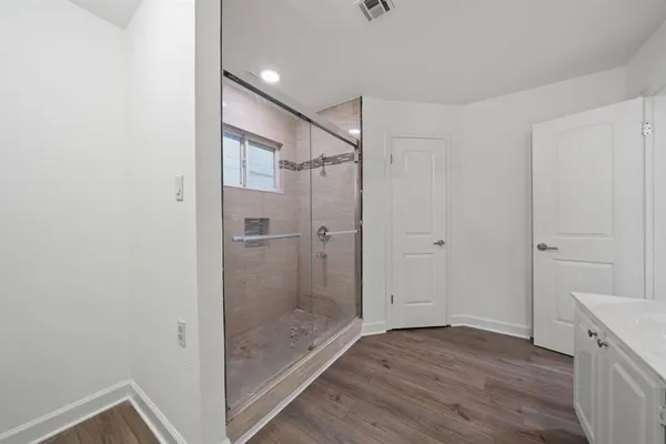 a view of a room with wooden floor