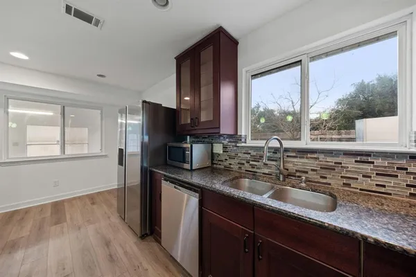 a spacious bathroom with a granite countertop sink