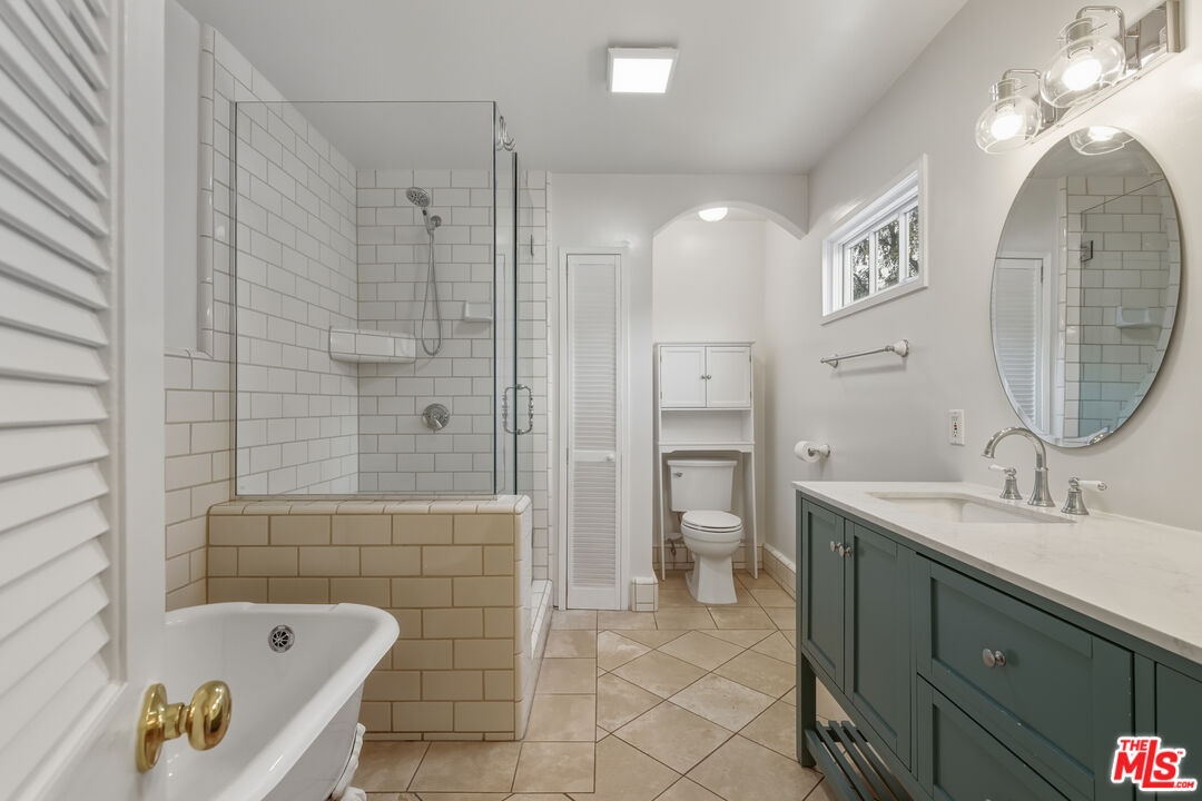 5967 Carpenter Avenue Valley Village, CA 91601 - Photo 15 of 32 a spacious bathroom with a bathtub shower sink and mirror