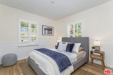 a bedroom with bed and a window