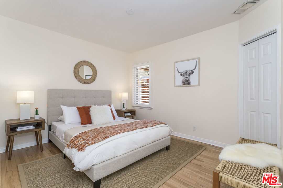 5967 Carpenter Avenue Valley Village, CA 91601 - Photo 19 of 32 a bedroom with a bed and a lamp