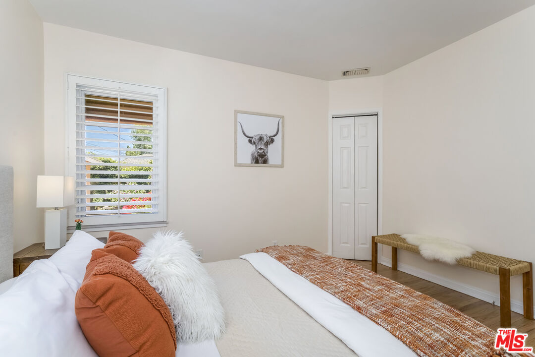 5967 Carpenter Avenue Valley Village, CA 91601 - Photo 20 of 32 a bedroom with a bed and a window