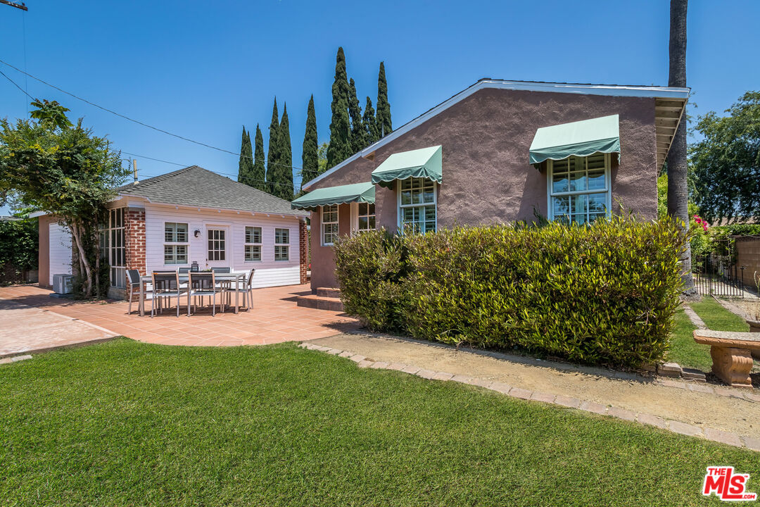 5967 Carpenter Avenue Valley Village, CA 91601 - Photo 27 of 32 a patio with a table and chairs under an umbrella