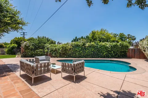 a view of a chairs and table in the patio
