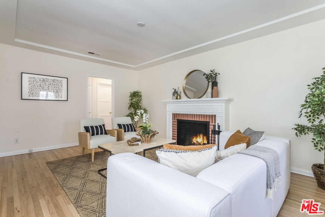 5967 Carpenter Avenue Valley Village, CA 91601 - Photo 7 of 32 a living room with furniture and a fireplace