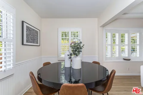 a dining room with furniture and wooden floor