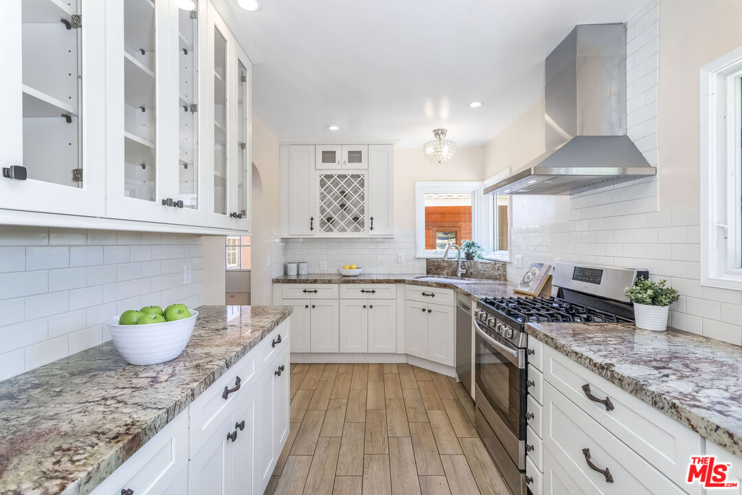 5967 Carpenter Avenue Valley Village, CA 91601 - Photo 10 of 32 a kitchen with stainless steel appliances granite countertop a sink stove and cabinets