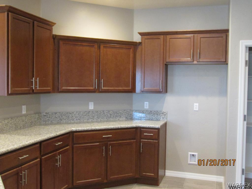 4276 East Cane Ranch Road Kingman, AZ 86401 - Photo 3 of 23 a kitchen with stainless steel appliances granite countertop wooden cabinets and a sink