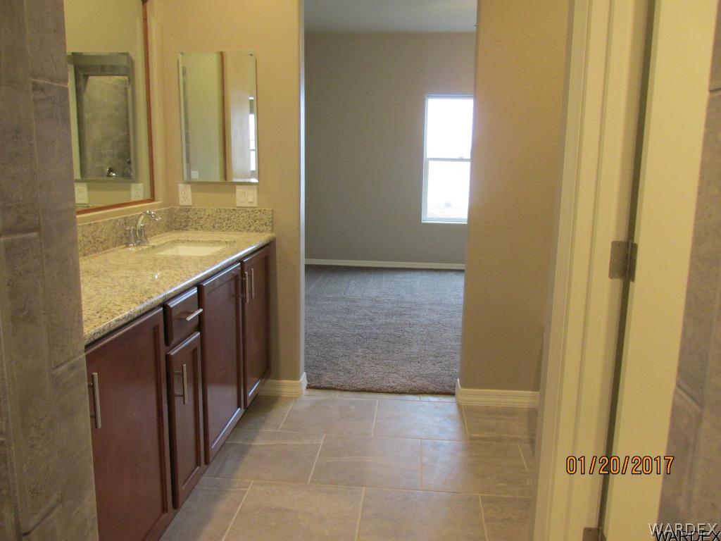 4276 East Cane Ranch Road Kingman, AZ 86401 - Photo 6 of 23 a bathroom with a granite countertop sink and a mirror