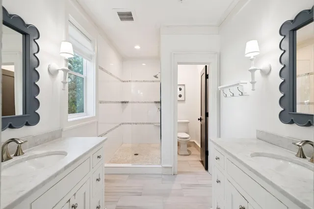 a kitchen with stainless steel appliances a stove a sink dishwasher a dining table and chairs with wooden floor