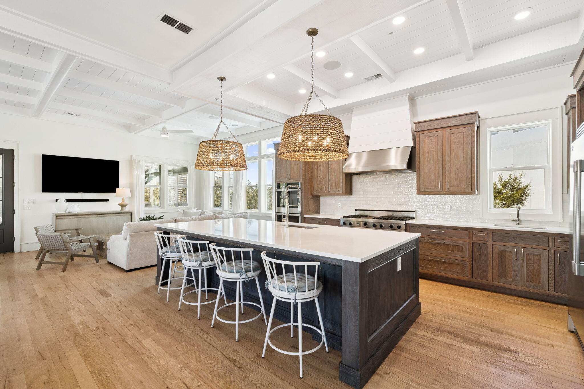 425 Beachfront Trail Santa Rosa Beach, FL 32459 - Photo 47 of 117 a kitchen with stainless steel appliances a stove a sink dishwasher a dining table and chairs with wooden floor