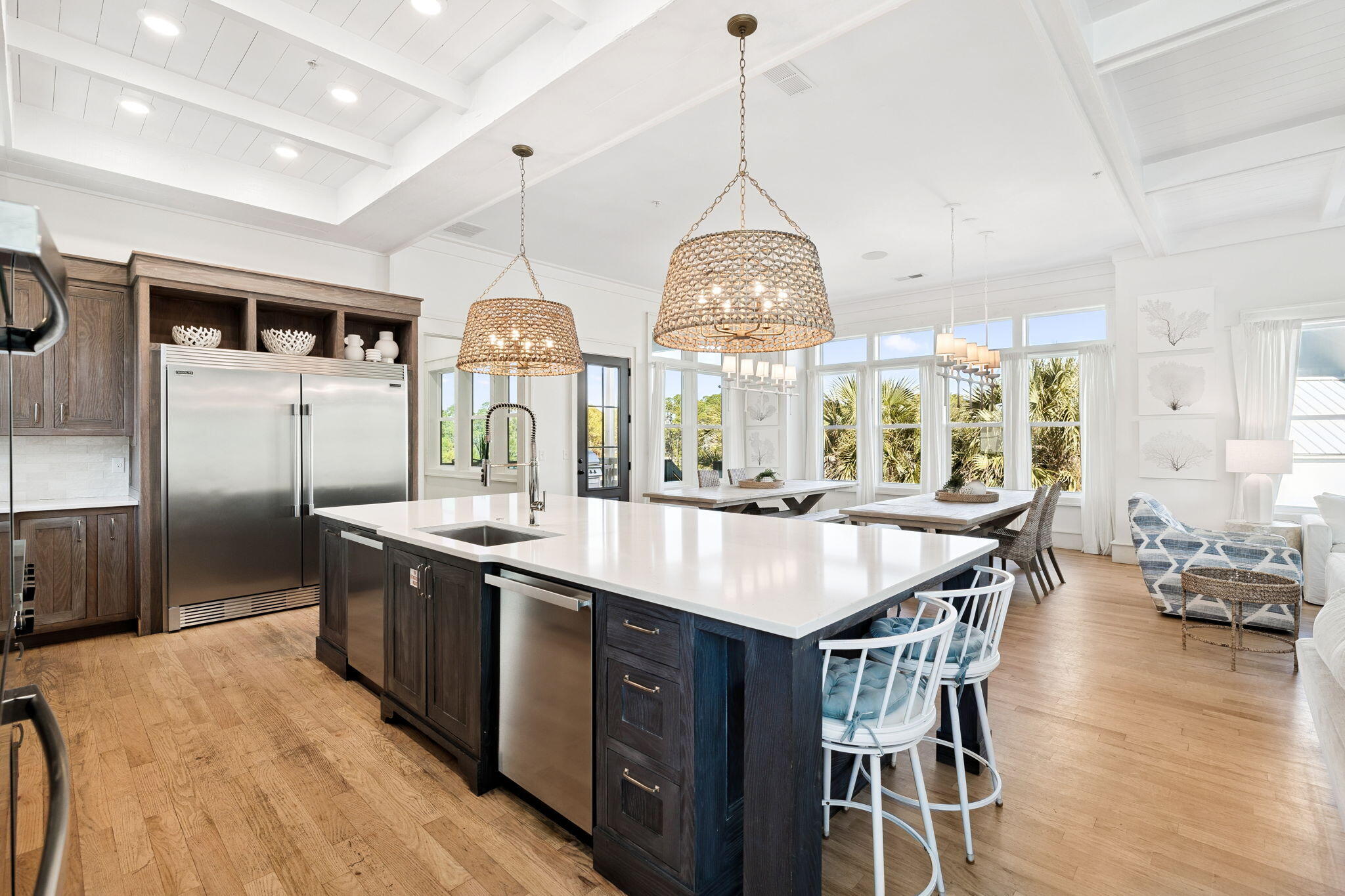 425 Beachfront Trail Santa Rosa Beach, FL 32459 - Photo 54 of 117 a kitchen with stainless steel appliances a table chairs and wooden floor