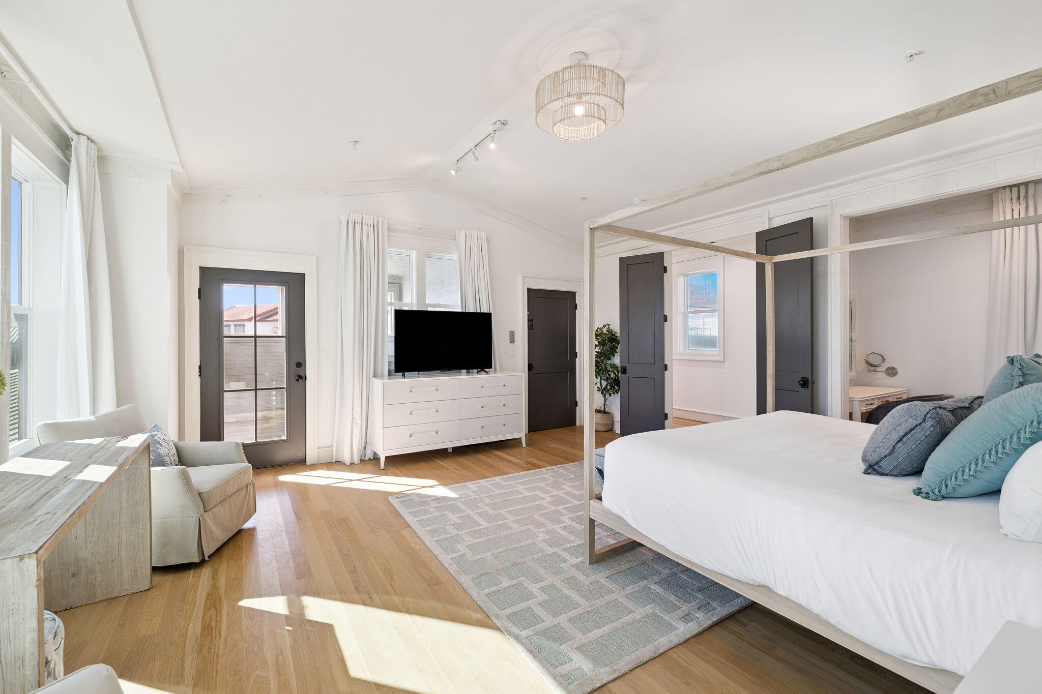 425 Beachfront Trail Santa Rosa Beach, FL 32459 - Photo 79 of 117 a spacious bedroom with a large bed a flat tv screen and a couch