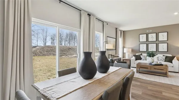 a living room with furniture and large windows