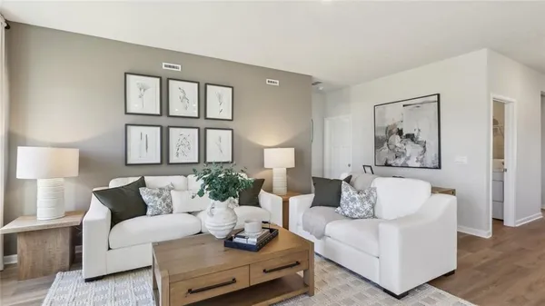 a living room with furniture and a potted plant on table
