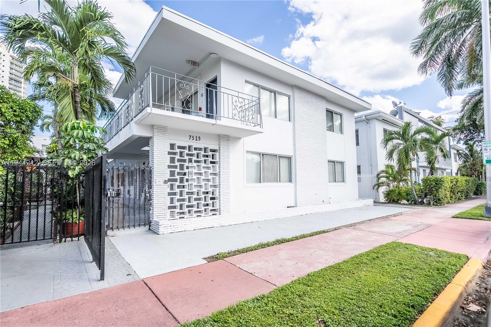 7315 Harding Avenue, Unit 16 Miami Beach, FL 33141 - Photo 1 of 13 a front view of a house with a garden