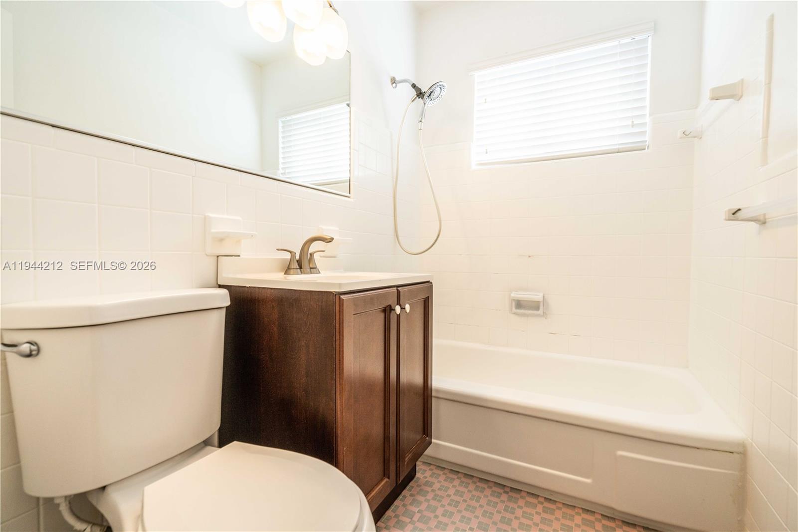 7315 Harding Avenue, Unit 16 Miami Beach, FL 33141 - Photo 11 of 13 a bathroom with a sink a toilet and shower