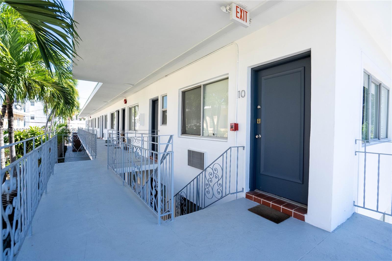 7315 Harding Avenue, Unit 16 Miami Beach, FL 33141 - Photo 12 of 13 a view of a porch with wooden floor and fence
