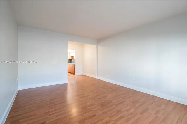 a view of an empty room and wooden floor