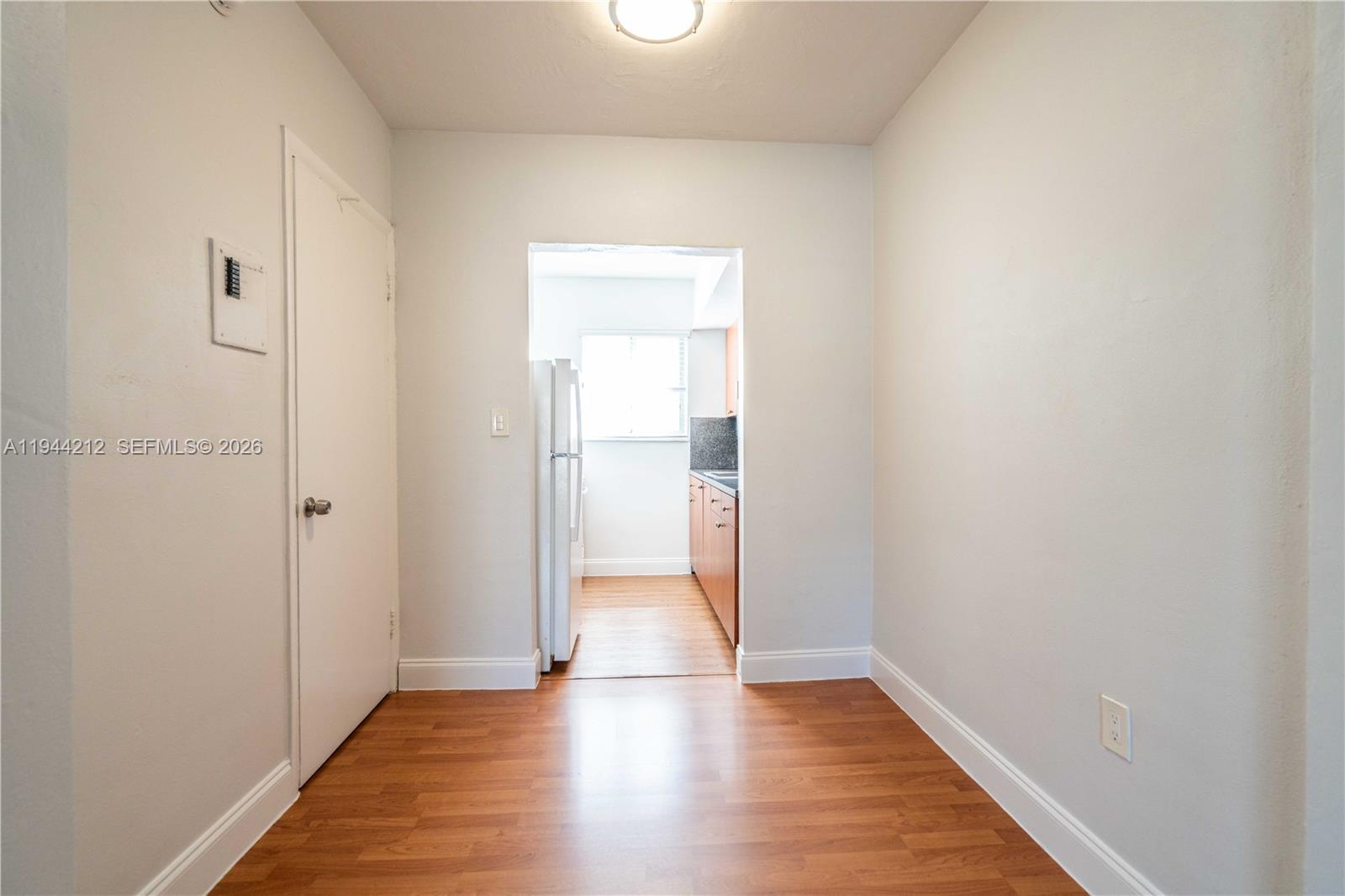 7315 Harding Avenue, Unit 16 Miami Beach, FL 33141 - Photo 6 of 13 a view of an empty room with wooden floor