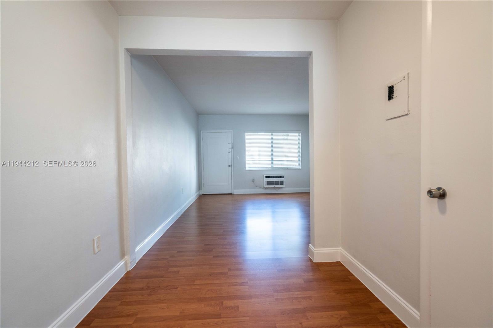 7315 Harding Avenue, Unit 16 Miami Beach, FL 33141 - Photo 7 of 13 a view of a hallway with wooden floor