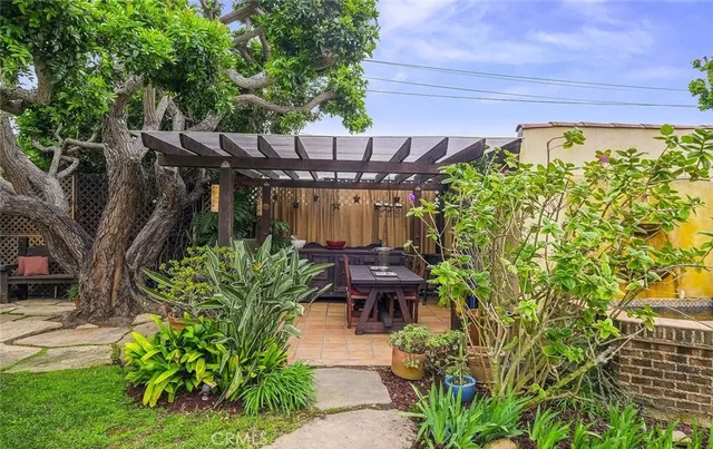 a view of a patio with table and chairs and potted plants