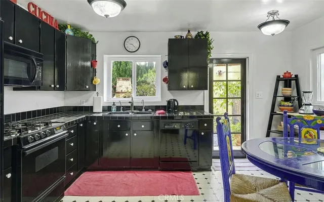 a kitchen with a stove a sink and a microwave