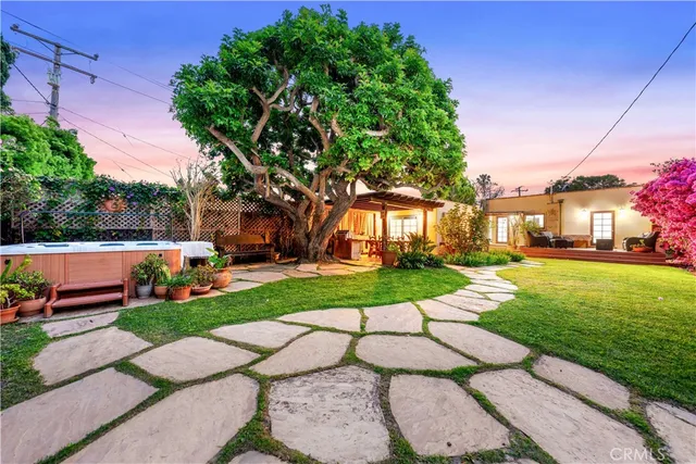a view of a park with plants and large trees