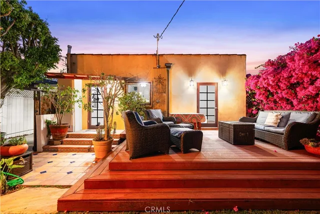 a living room with furniture a lamp and a potted plant